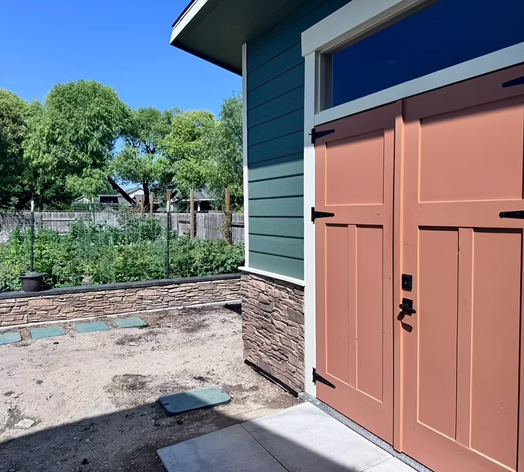 Custom shed: a stone-veneer base ties it into the yard