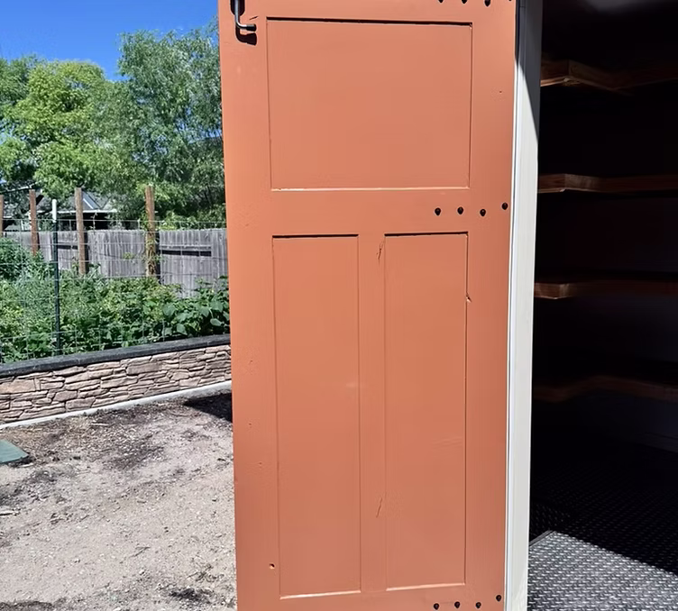 Custom shed: solid entry door and finished threshold