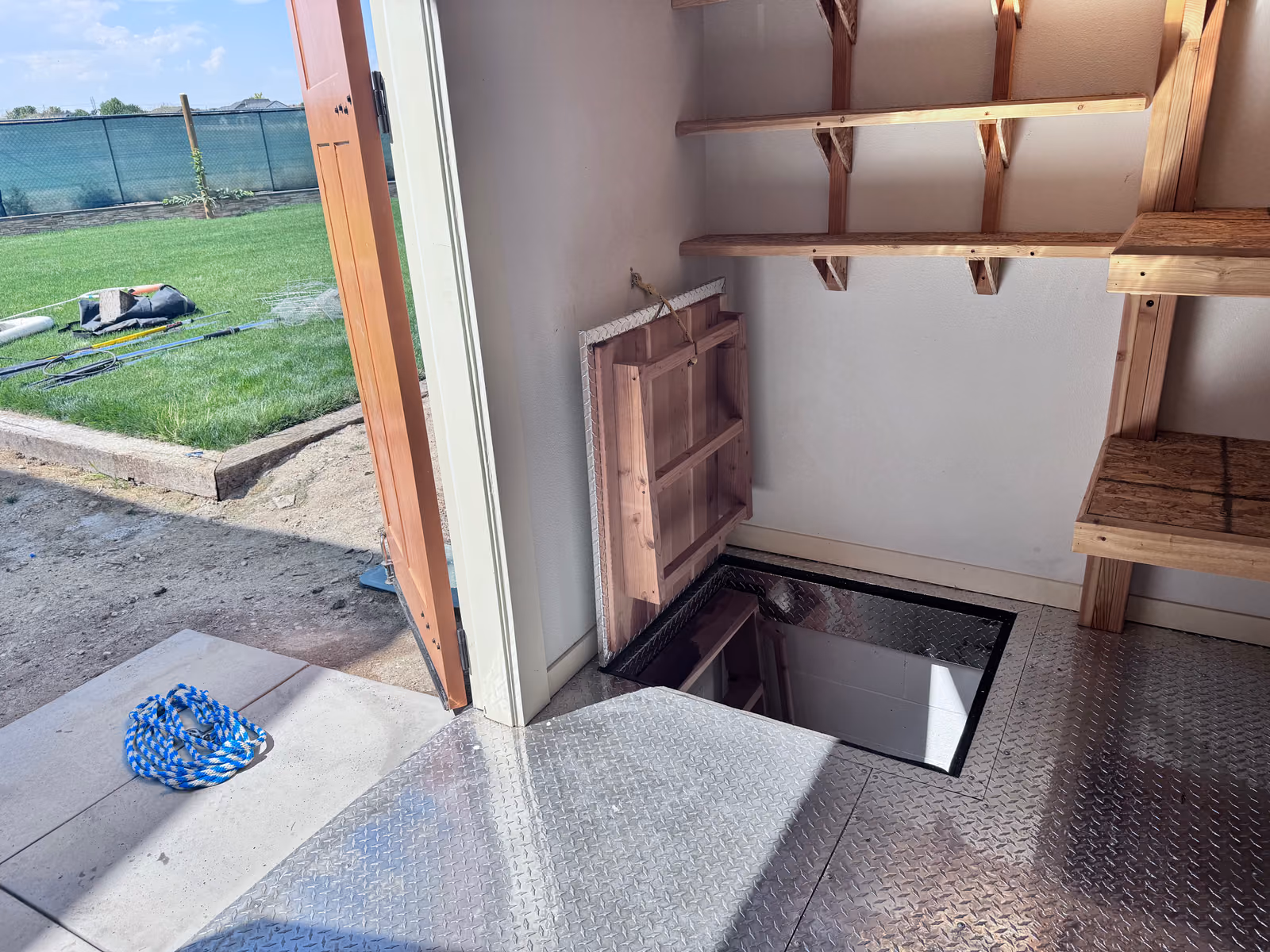 The hatch in the custom shed's floor, open
